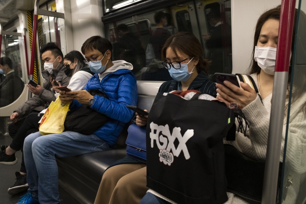 Passengers wearing medical masks ride an MTR train in Hong Kong. Photo: Sun Yeung