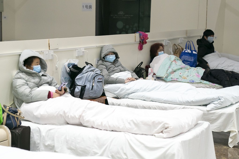 A patient uses her smartphone at a makeshift hospital converted from an exhibition centre in Wuhan, in central China’s Hubei province, on February 5, 2020. Photo: Xinhua