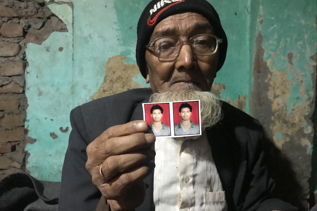 Aleem Ansari’s 85-year-old father, Habib, holds a photo of his slain son. Photo: Ashish Malhotra