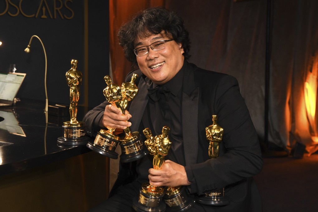 Bong Joon-ho holds the Oscars for best original screenplay, best international feature film, best directing, and best picture for Parasite at the Governors Ball after the Oscars on Sunday at the Dolby Theatre in Los Angeles. Photo: Richard Shotwell/Invision/AP