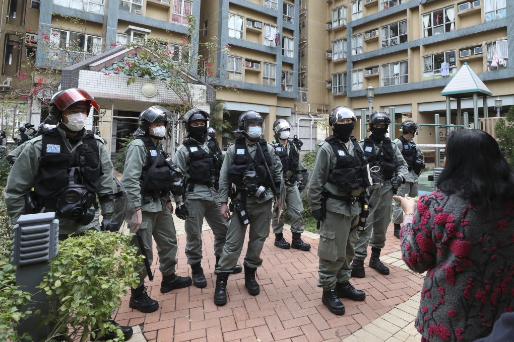 Residents unhappy with plans for a nearby quarantine facility quarrel with riot police at Lakeside Garden in Sai Kung who warned them they were taking part in an illegal assembly. Photo: Nora Tam