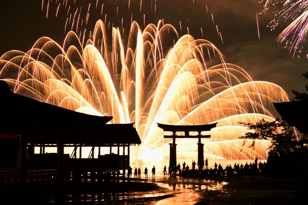 Fireworks light up the sky over Itsukushima Shrine on Miyajima island in August 2016. Photo: Kyodo