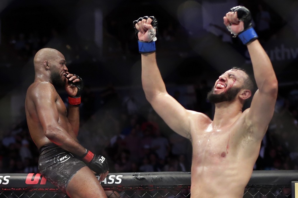 Jon Jones sits on the Octagon fence as Dominick Reyes celebrates following their light heavyweight title fight at UFC 247 in February. Photo: AP