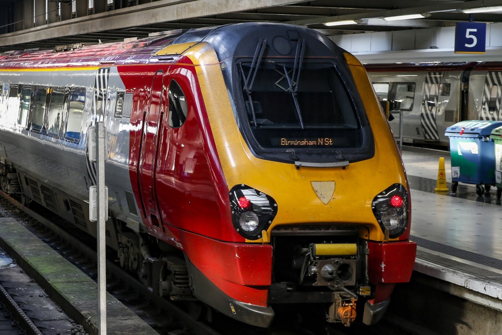 A train bound for Birmingham New Street station waits on a platform at London Euston railway station. The UK's HS2 High Speed Rail project linking London to northern England is behind schedule and over budget. Photo: Bloomberg