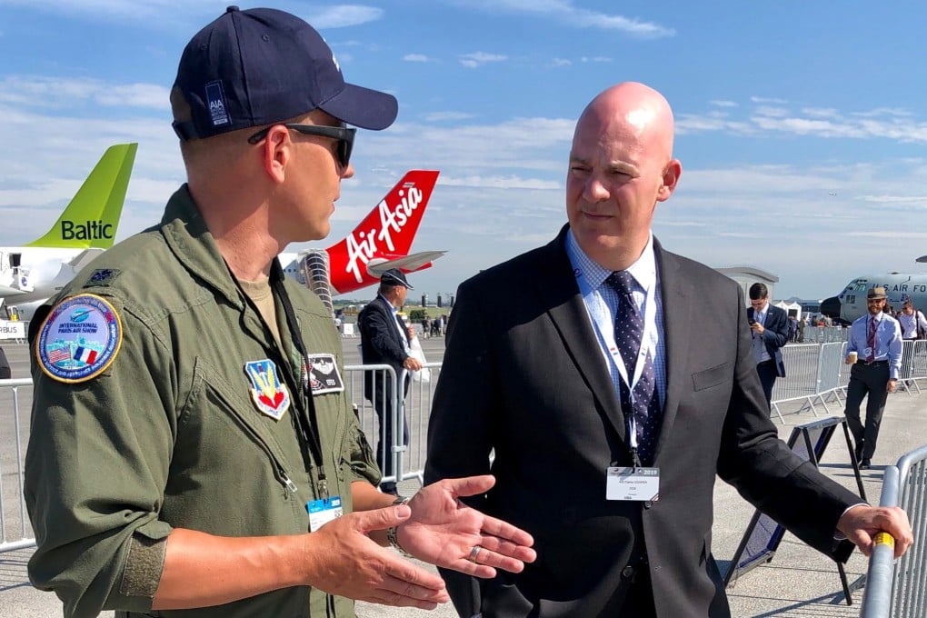 R. Clarke Cooper (right), assistant secretary of state for political-military affairs, with a US Air Force pilot at a recent air show in Paris. Photo: US Department of State