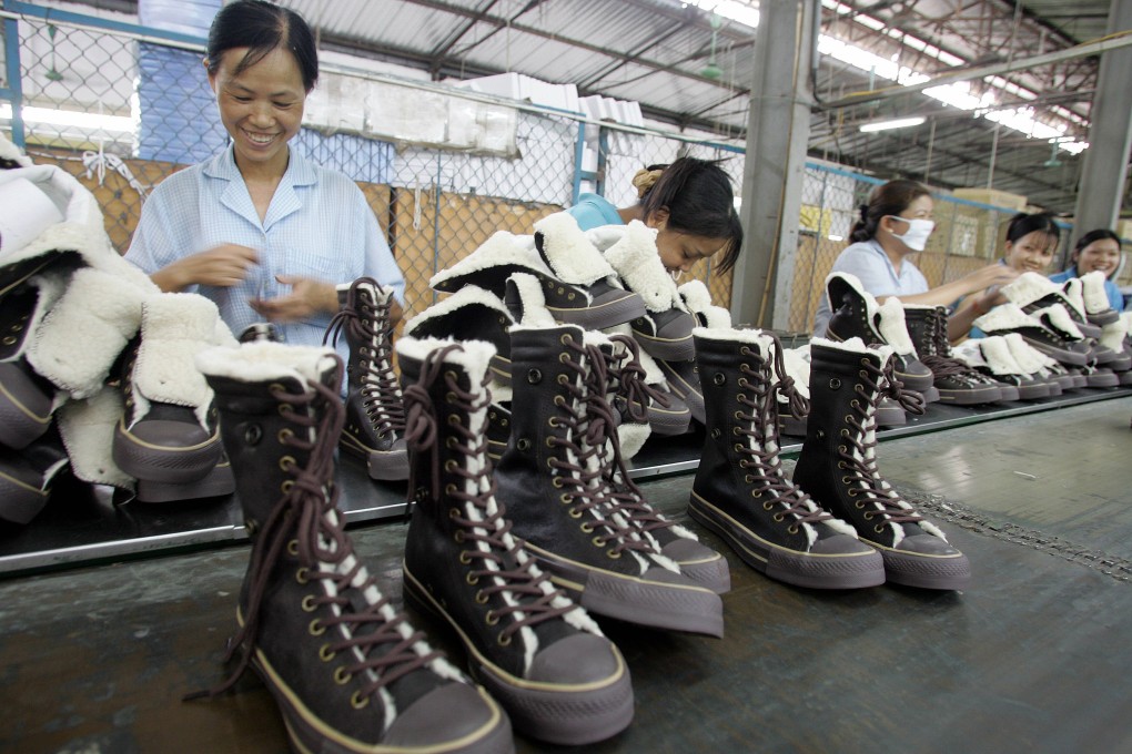 Workers sew shoes inside a factory in Hanoi, Vietnam. Photo: AFP