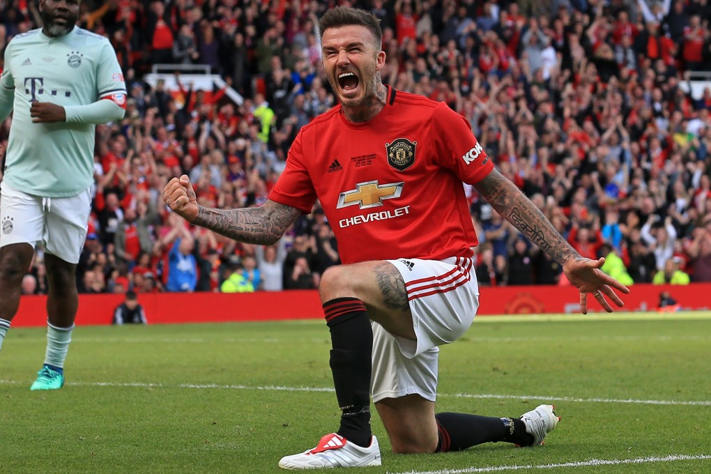 Manchester United 1999 Legends player David Beckham celebrates scoring during the Treble Reunion 20th anniversary match against FC Bayern Legends at Old Trafford. Photo: AFP