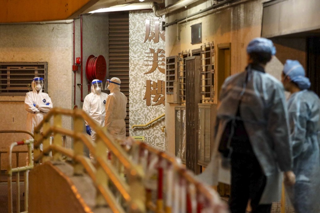 Health workers outside the exit of Hong Mei House in Cheung Hong Estate. Photo: Felix Wong