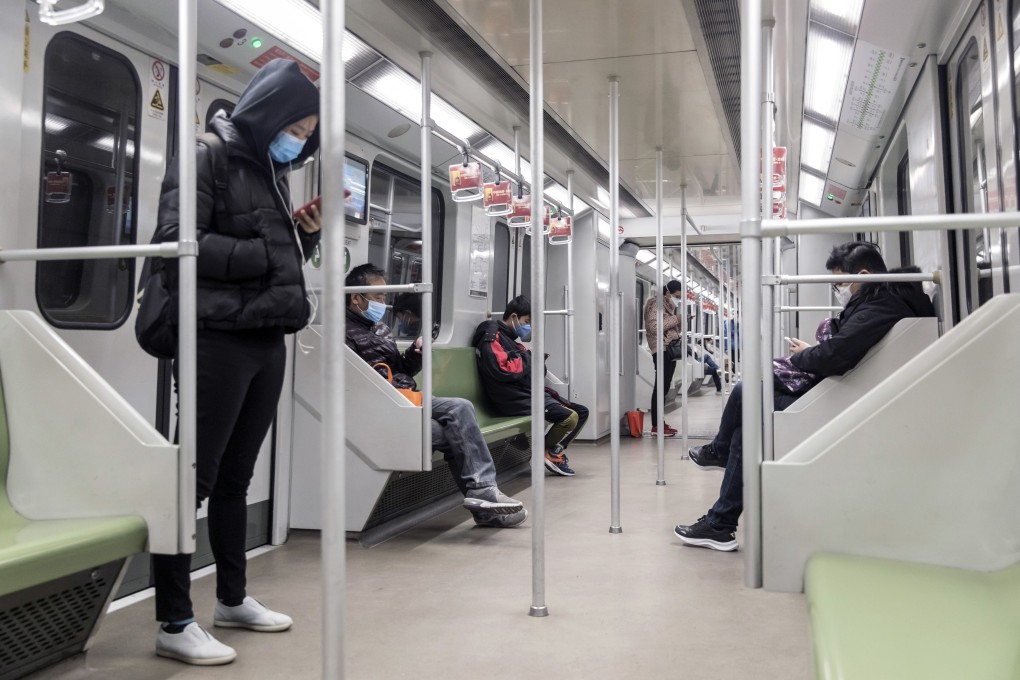 Commuters wearing protective masks ride a subway train after the extended Lunar New Year break in Shanghai on February 10. Photo: Bloomberg