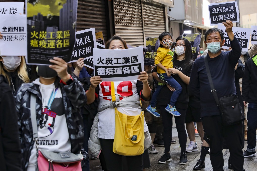 Protesters in Fo Tan holding up slogans against a plan to turn a public estate into a quarantine site. Photo: Sam Tsang