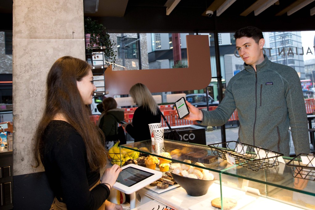 A Karma app user collecting his food, ordered through the food-sharing app, from a Coco Di Mama food outlet in London. Photo: AFP