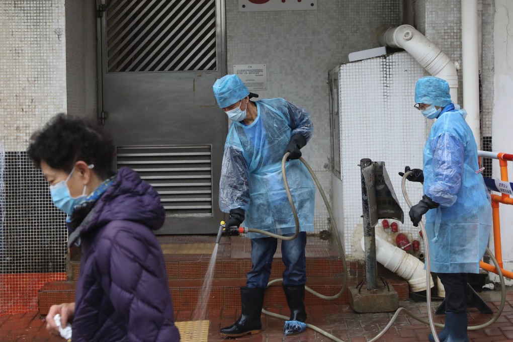 Health workers disinfect a public walkway near Hong Mei House in Cheung Hong Estate in Tsing Yi. Photo: Sam Tsang