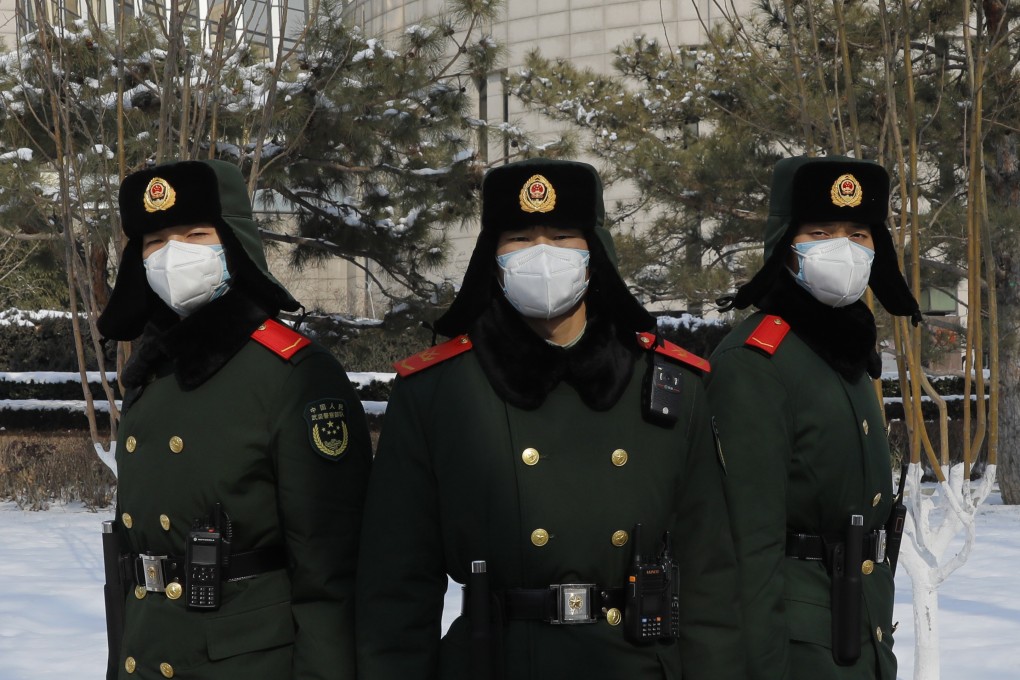 Chinese paramilitary police officers wearing face masks stand outside the headquarters of the People's Bank of China in Beijing on February 7. While some analysts have said China’s economy could be adversely affected by the coronavirus, the Chinese central bank has already injected a large amount of liquidity into the system. Photo: EPA-EFE