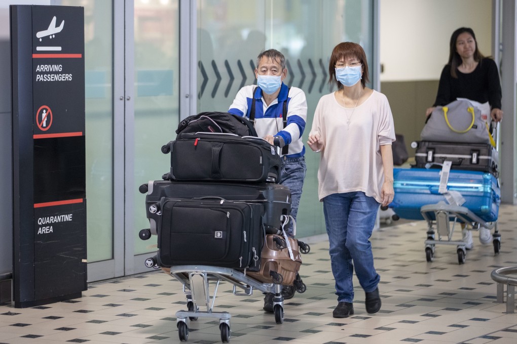 Passengers wear protective face masks at Brisbane International Airport. Photo: EPA