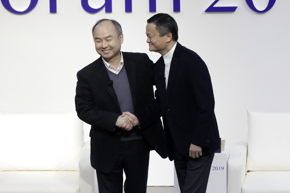 Masayoshi Son, chairman and chief executive officer of SoftBank Group, left, and Jack Ma, former chairman of Alibaba Group Holding, shake hands at Tokyo Forum 2019 on December 6, 2019. Photo: Bloomberg