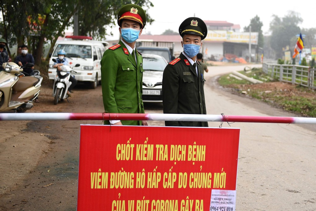 Vietnamese police stand guard at a checkpoint in Son Loi commune in Vinh Phuc province. Photo: AFP
