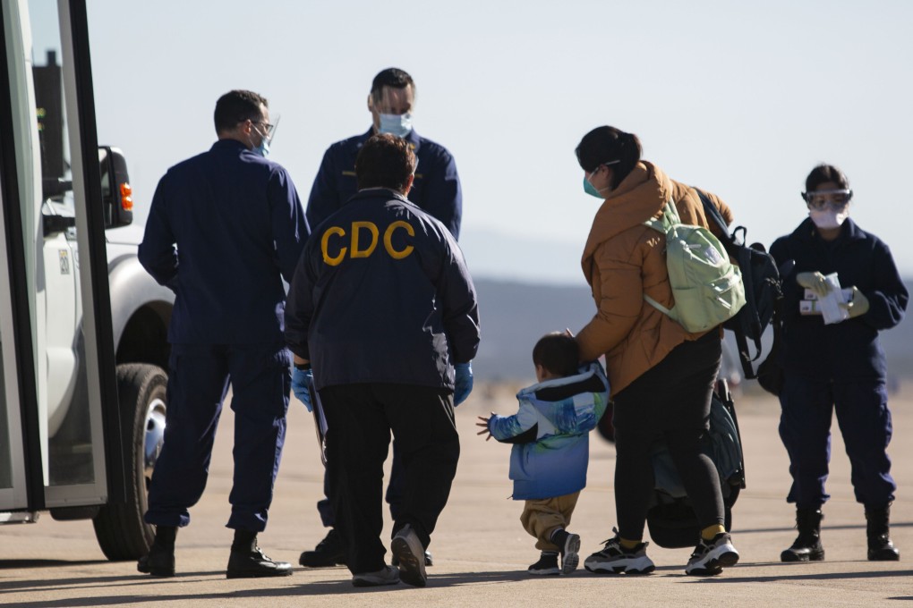 A CDC representative assists evacuees from China who have just arrived the Marine Corps air station in southern California on February 5. Photo: US Department of Health and Human Services/Lance Corporal Krysten Houk via AP