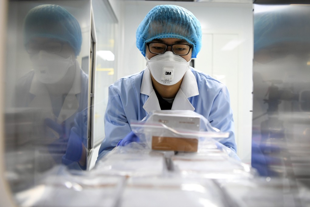 A researcher delivers detection reagents for the new coronavirus at a company in Tianjin, China. Photo: Xinhua