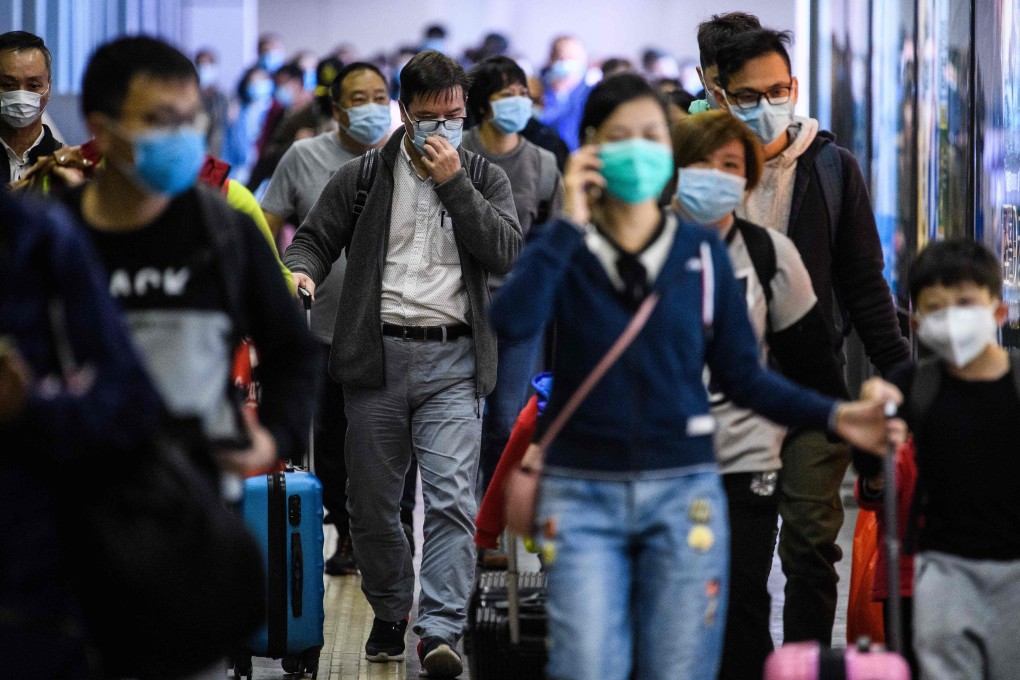 Passengers wear face masks as they arrive from Shenzhen at Lo Wu MTR station, hours before the closing of the Lo Wu border crossing in Hong Kong on February 3. Photo: AFP