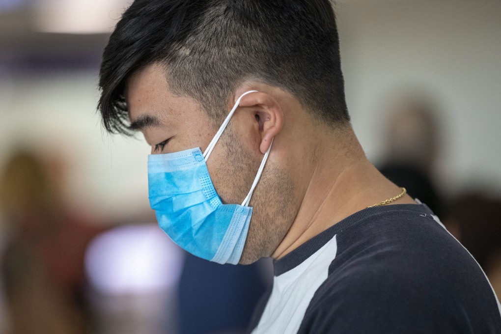 A passenger wears a protective face mask at Brisbane International Airport in Australia. Photo: EPA