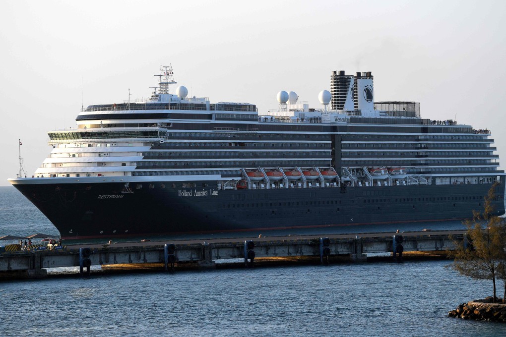 Passengers watch as the Westerdam cruise ship arrives at the port in Sihanoukville on Cambodia's southern coast on February 13, after being refused entry at other Asian ports due to fears of the Covid-19 coronavirus. Photo: AFP