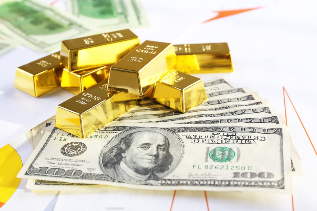 Gold bars with US dollar banknotes. Photo: Shutterstock