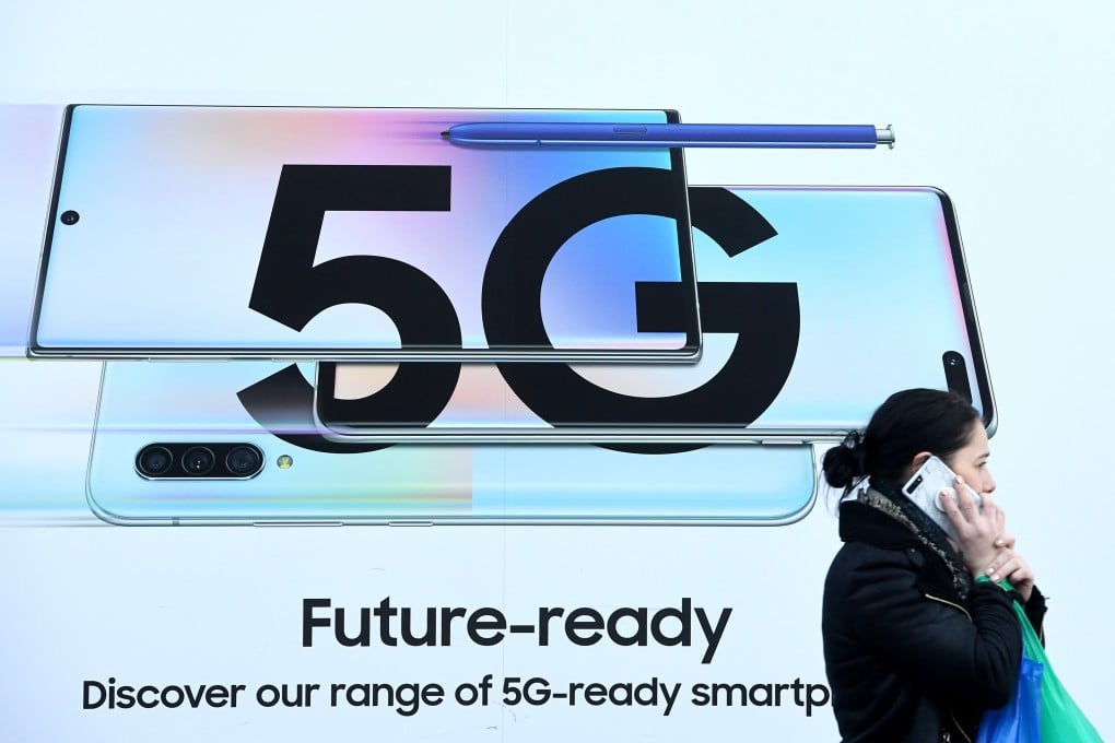 A pedestrian walks past a 5G advertisement in London on January 29. Photo: EPA-EFE