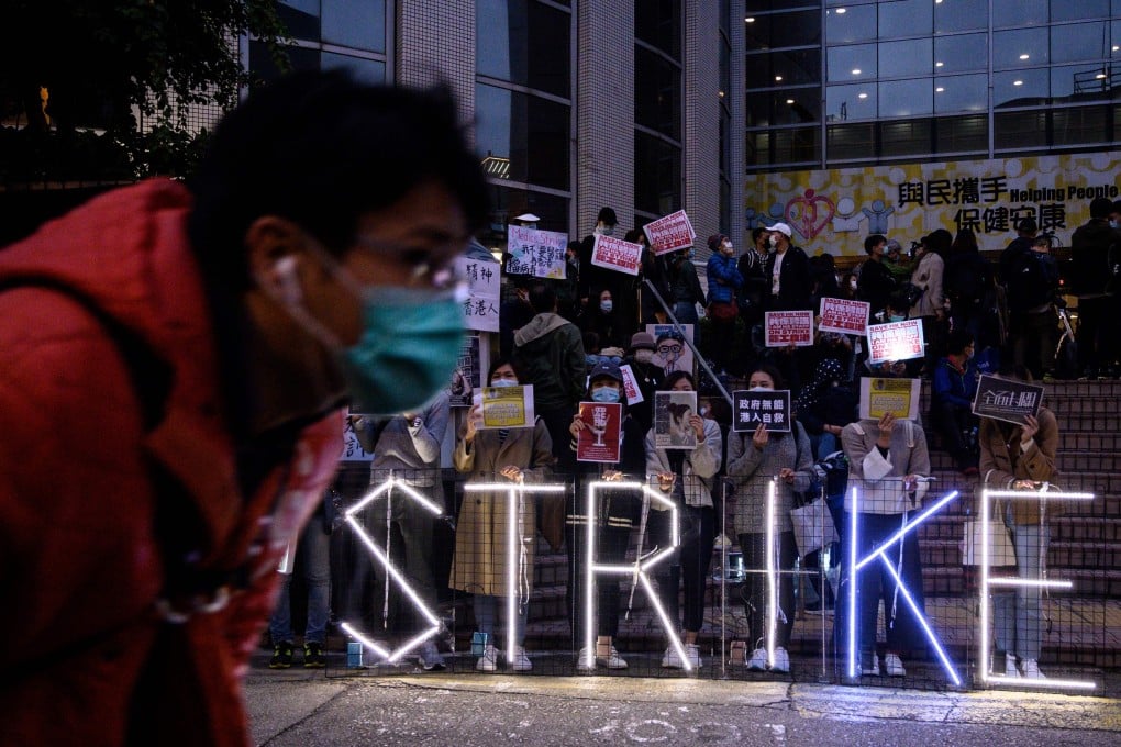 Striking members of the Hospital Authority Employees Alliance and other activists gather at the Hospital Authority building on February 7, calling for the closing of Hong Kong’s border with the mainland. Photo: AFP