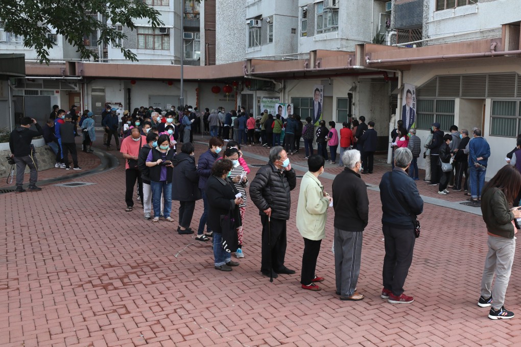 Residents queue for masks sponsored by a chain store, at Hong Mei House in Cheung Hong Estate, Tsing Yi, on February 12. More than 100 residents were evacuated the previous day after coronavirus cases were diagnosed in the block. Photo: Xiaomei Chen