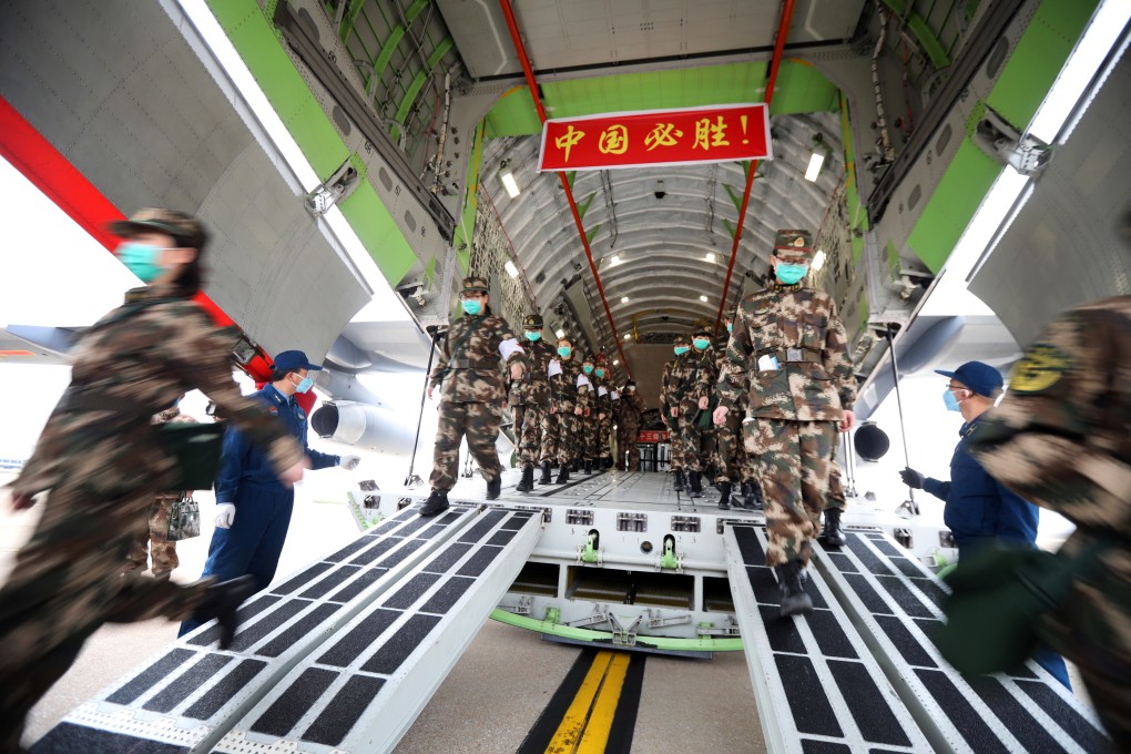 Medical personnel arrive in Wuhan with medical supplies on a PLA transport aircraft on Thursday. Photo: China Daily via Reuters