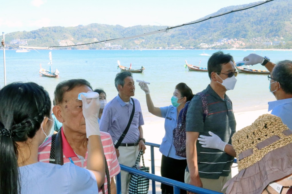 Thai health officials take the temperatures of tourists arriving in Phuket via cruise ship on Thursday. Photo: EPA-EFE