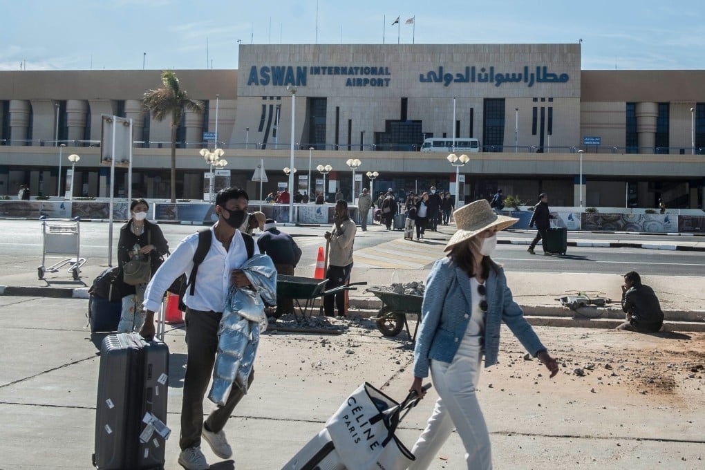 Passengers wearing masks leave Aswan International Airport in Egypt on February 2. Photo: AFP
