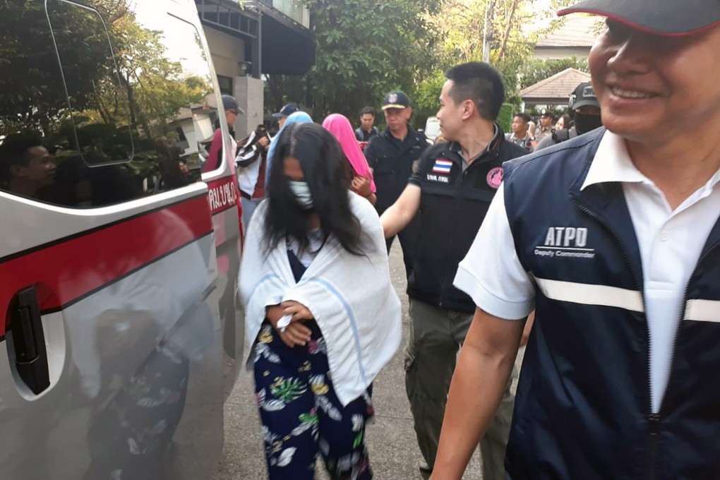 Thai police officers arrest a suspected surrogate mother after a raid at a house in Bangkok on Thursday. Photo: Royal Thai Police via EPA-EFE