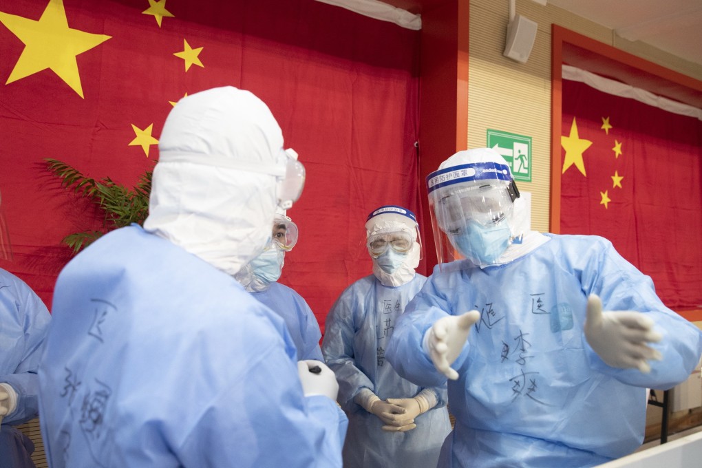 Medical staff in discussion at a makeshift hospital to treat coronavirus patients in Wuhan on Friday. Photo: EPA-EFE