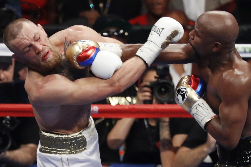 Floyd Mayweather Jnr (right) hits Conor McGregor with a right straight during their boxing crossover fight in Las Vegas in 2017. Photo: AP