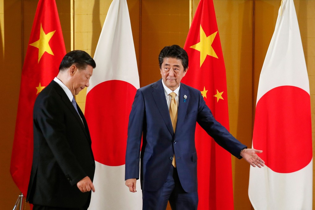 Chinese President Xi Jinping (left), pictured during talks with Japanese Prime Minister Shinzo Abe in Osaka last June, is still expected to visit Japan in April. Photo: AFP