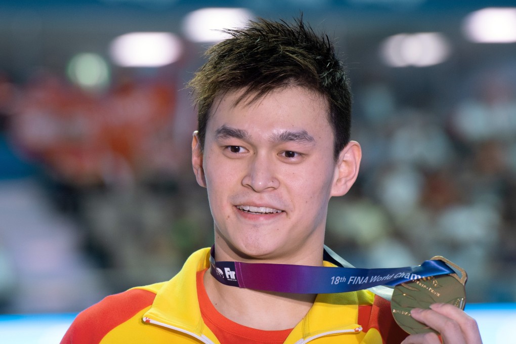 Chinese swimmer Sun Yang holds his gold medal after wining the 200m freestyle at the 2019 world championships. Photo: DPA
