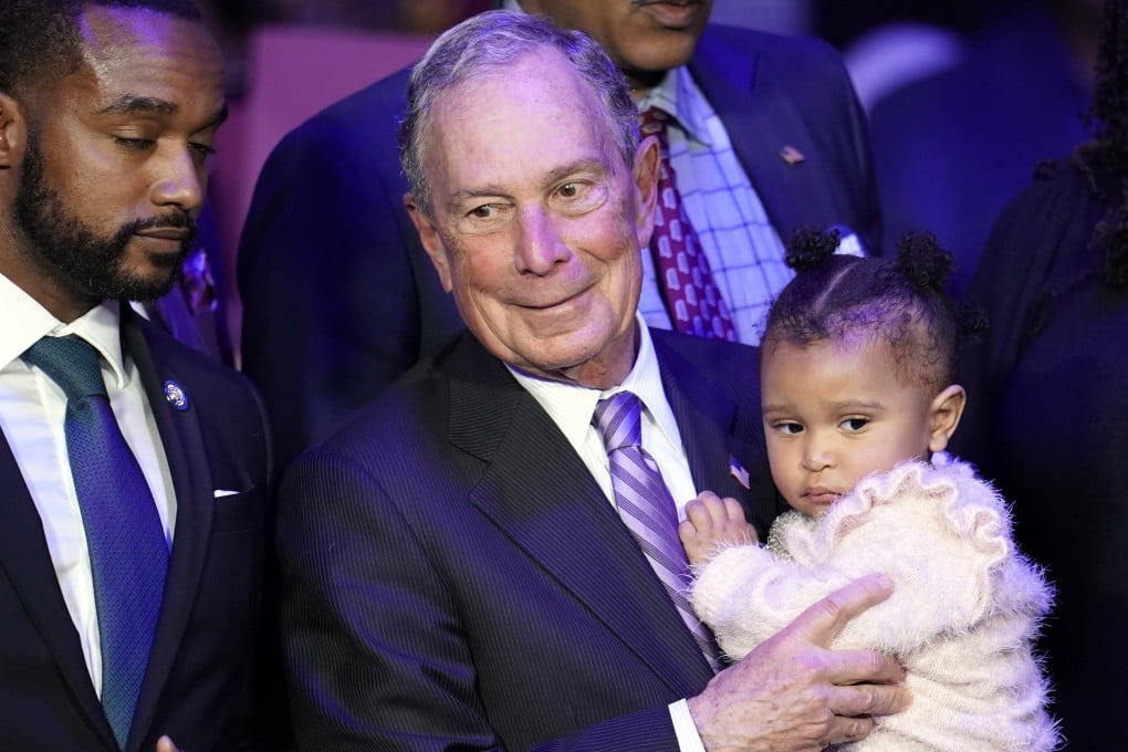 Democratic presidential candidate and former New York City mayor Michael Bloomberg holds a toddler during his campaign launch of ‘Mike for Black America’, in Houston. Photo: AP