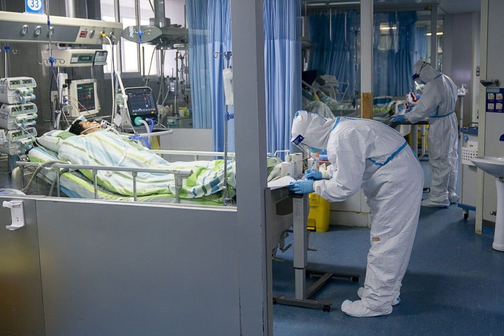 A medical worker attends to a patient suffering from Covid-19 in Zhongnan Hospital, in Wuhan, Hubei province. Companies from across the world are speeding up efforts to find a cure for the pneumonia-like disease caused by the coronavirus. Photo: Xinhua via AP