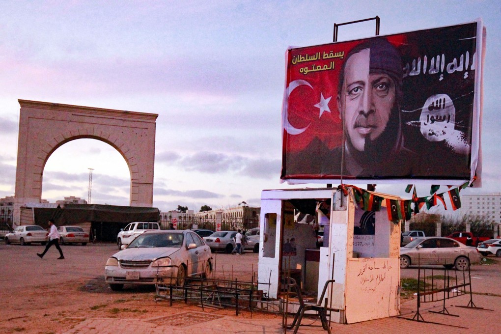 A large hoarding shows the face of Turkish President Recep Tayyip Erdogan fading into the flag of the Islamic State (IS) group in the coastal city of Benghazi in eastern Libya. Photo: AFP