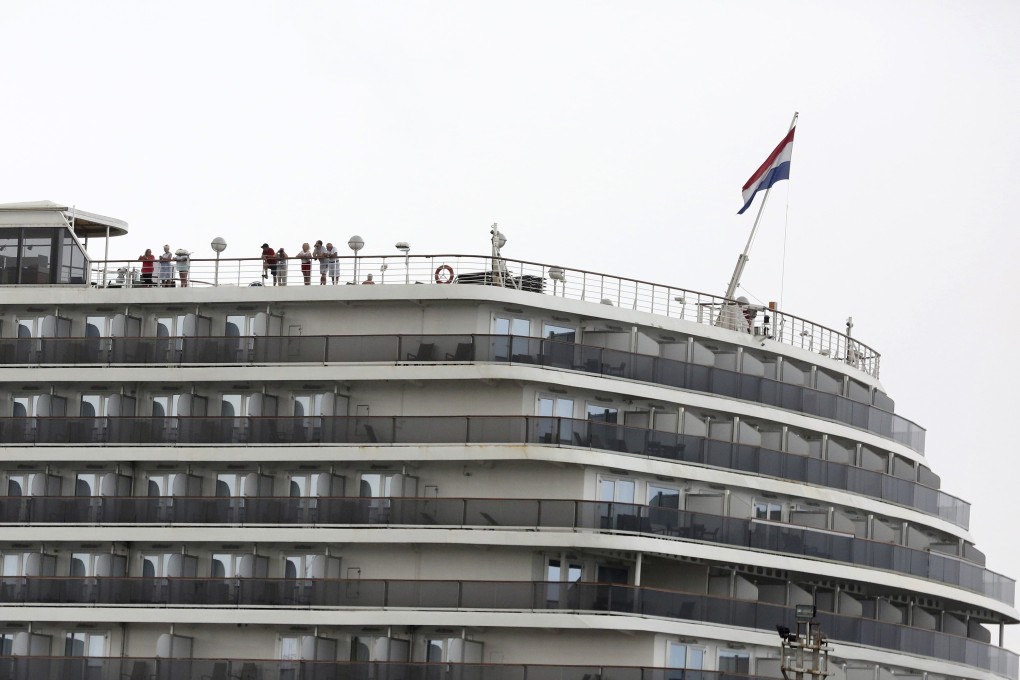 Passengers stand on the top deck of the MS Westerdam while the cruise ship is docked in Sihanoukville, Cambodia. Photo: AP