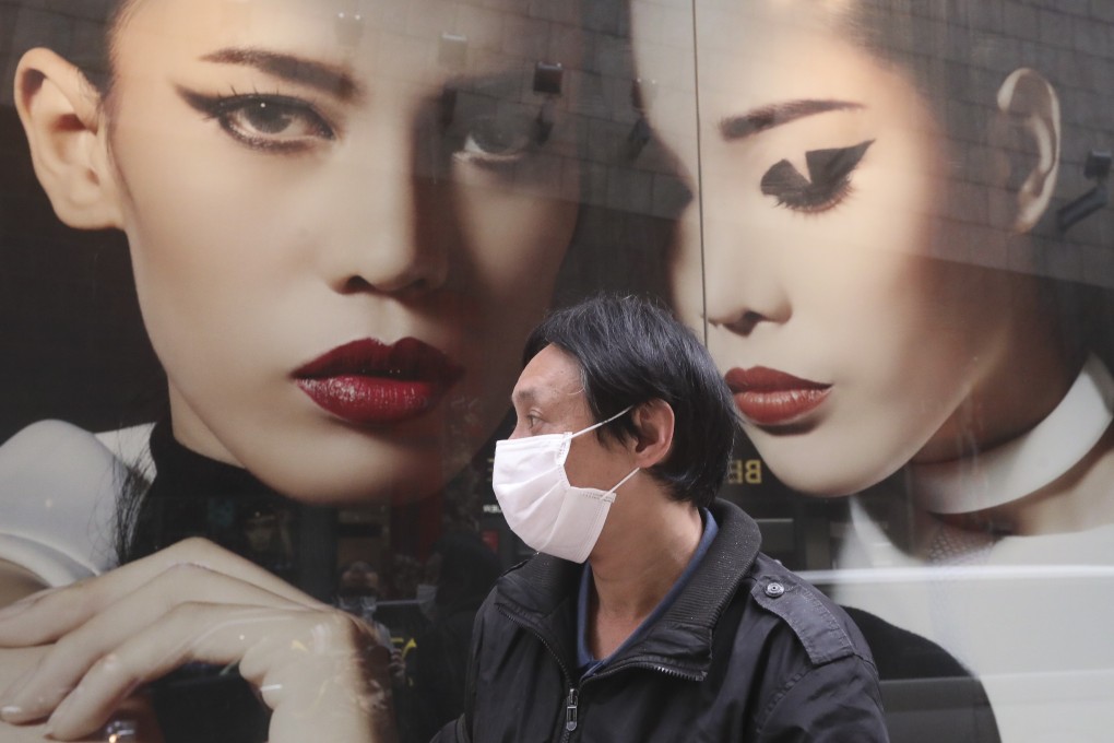 A man queues up for a free face mask in Mong Kok. Photo: Felix Wong