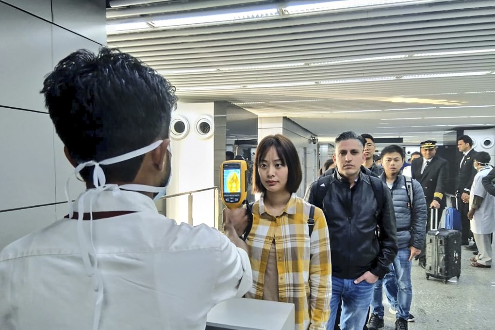 Passengers have their temperatures taken at Netaji Subhash Chandra Bose International Airport in Kolkata. Photo: AFP