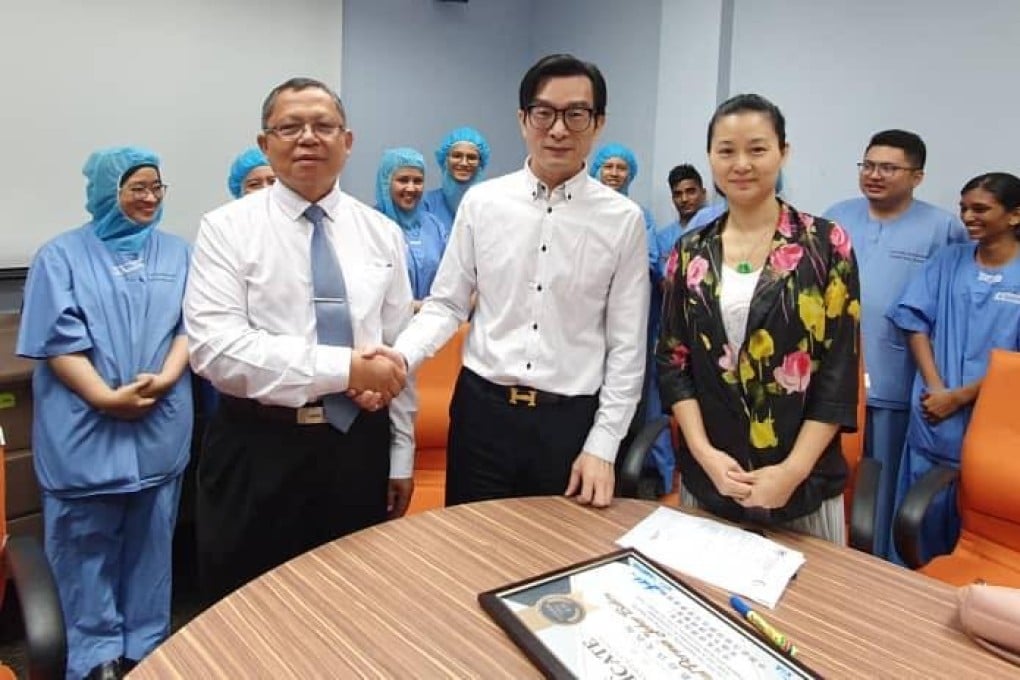 The couple (seen centre in white shirt and flower-patterned blouse) received treatment at Hospital Permai in Johor Baru. Photo: Facebook