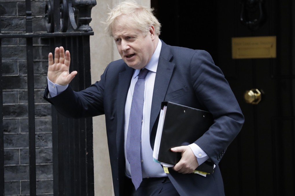 British Prime Minister Boris Johnson waves at the media as he leaves No 10 Downing Street in London on Wednesday. Photo: AP