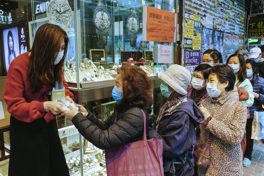 Elderly people queue up for free protective face masks given out at a shop in Causeway Bay, Hong Kong, on February 10, amid a running shortage. Photo: Robert Ng