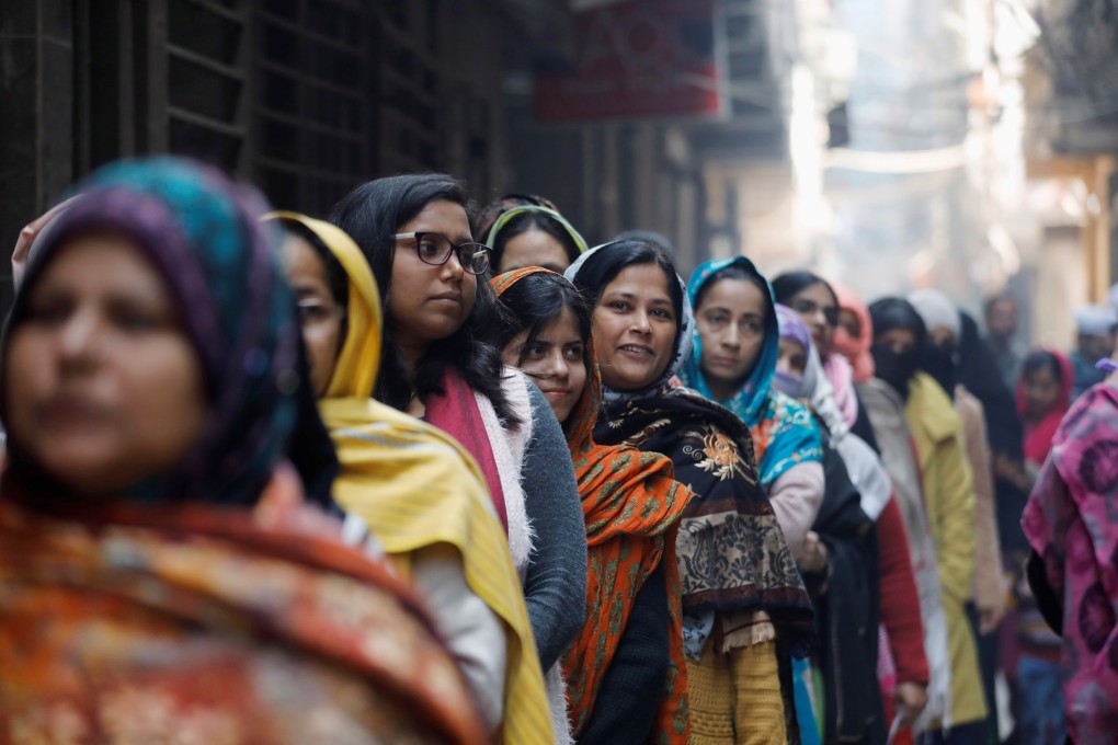 Women wait to cast their vote outside a polling booth during the state assembly election, in Shaheen Bagh, New Delhi, on February 8. Photo: Reuters