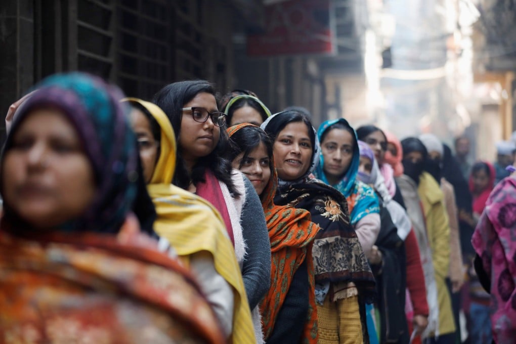 Women wait to cast their vote outside a polling booth during the state assembly election, in Shaheen Bagh, New Delhi, on February 8. Photo: Reuters