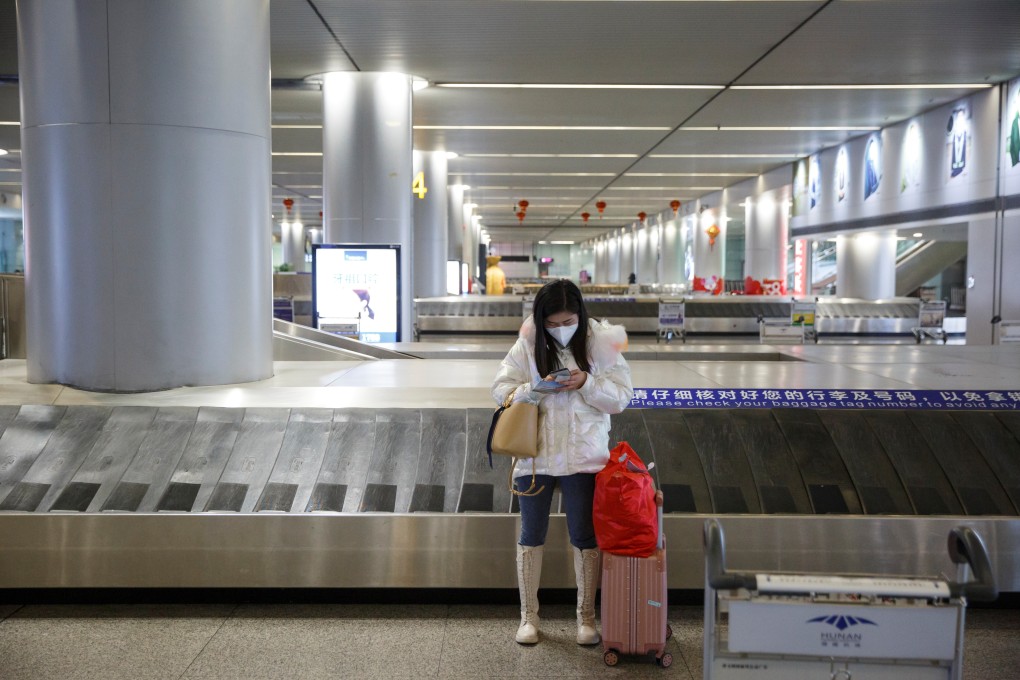 A passenger waits in an empty luggage collection hall in Changsha, Hunan province last month. Chinese airlines have been the hardest hit. Photo: Reuters