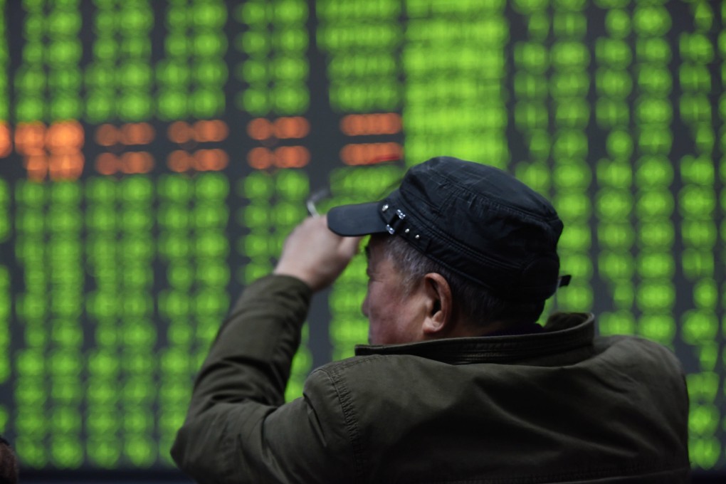 A stock investor in front of a display screen at a brokerage in the Zhejiang provincial capital of Hangzhou on 3 February 2020. Contrary to global conventions, China depicts gains and advances in red, and denotes losses and declines in green. Photo: EPA-EFE